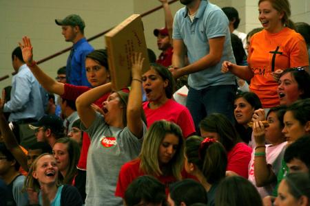 Students cheer and catch the pizzas that are thrown to them during bulldog madness. - Photo by Kristi McMurry Woody