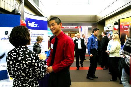Danny Song, senior journalism major, talks with Rachel Hughes about career opportunities at the CareerU fair.  - Photo by Kristi McMurry Woody