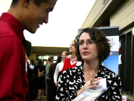 Danny Song, senior journalism major, talks with Rachel Hughes about career opportunities at the CareerU fair.  - Photo by Kristi McMurry Woody