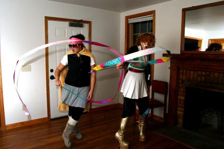 Rose Rogers and Lily Zophi, both senior art majors, twirl the ribbons that are part of their costumes for the art retreat costume party. - Photo by Kristi McMurry Woody