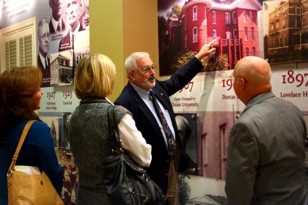 Jim Bryant, hall of fame inductee, points to the mural in the Carl Grant Event Center as Lisa and Cyndi Bryant and David Blackstock listen to his story.   - Photo by Kristi McMurry Woody