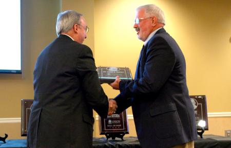 President Dockery presents Jim Bryant his induction plaque for the sports hall of fame. - Photo by Kristi McMurry Woody