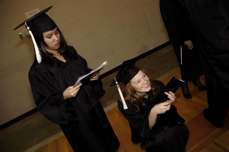 Rachel Vo, family studies major, and Lily Sopfi, art major, tire from standing in line before fall graduation. - Photo by Beth Spain