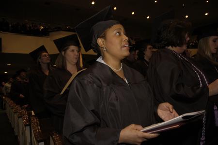 Donna Waddell sings the Alma Mater at the end of the fall graduation ceremony. - Photo by Beth Spain