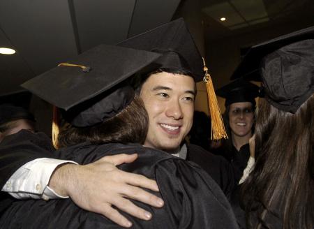 Danny Murphy, nursing major, congratulates friends after the fall graduation ceremony. - Photo by Beth Spain
