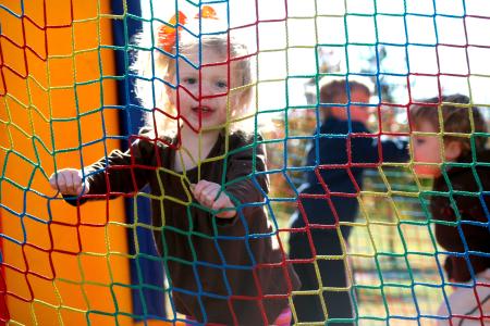 Cally Hope Maxwell, daughter of Paul and Amy Maxwell of Knoxville, bounces in the moon bounce at Homecoming's Arts in the Park. - Photo by Kristi McMurry Woody