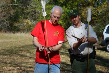 History chair Stephen Carls takes direction from Pinson Mounds park ranger Wesley Williams about atlatl spear-throwing during an afternoon learning session on Day of Remembrance.   - Photo by Kristi McMurry Woody