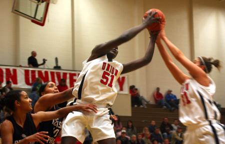 Teammates Josephine Owino and Merideth Richardson Jacobs both go up for a rebound during the third game of the Rotary Classic.  - Photo by Kristi McMurry Woody