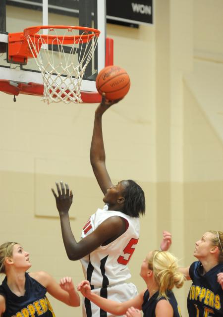 Senior center Josephine Owino lays the ball in the basket over defenders from Blue Mountain (Miss.) College. - Photo by Morris Abernathy