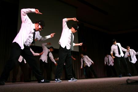 The men of Alpha Tau Omega used a Men in Black theme for their variety show act, which included many interesting dance moves. - Photo by Kristi McMurry Woody