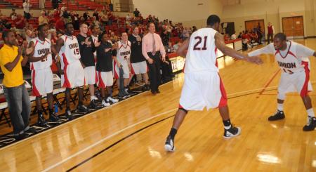 Martez Hawkins (13) congratulates teammate Brian Lake (21), after Lake scored to give Union the lead for good in the Bulldog's win over Martin Methodist (Tenn.) College in the TranSouth Conference Tournament. - Photo by Morris Abernathy