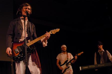Andrew Norman, sophomore philosophy major, performs with his band in the SAC Variety Show. - Photo by Angela Abbamonte
