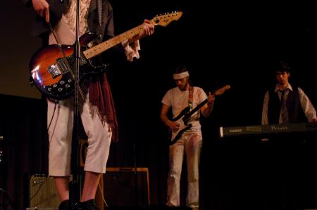 Andrew Norman, sophomore philosophy major, performs with his band in the SAC Variety Show. - Photo by Angela Abbamonte