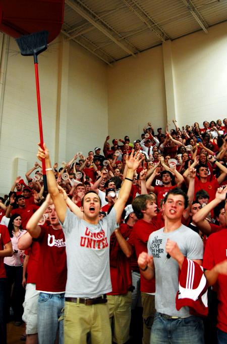 Union students Jay Landham and Chase Toggle lead the crowd in cheering as the Bulldogs win the TranSouth Conference Tournament Finals against Freed-Hardeman. - Photo by Kristi McMurry Woody