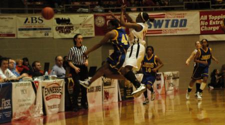 A Jarvis Christian player swats the ball out of bounds during the second half of the first game of the NAIA tournament on Wednesday. - Photo by Beth Spain