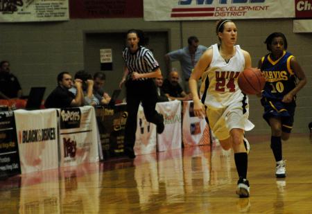 Sophomore Laura Crittendon drives the ball down the court during the last half of the first game of the NAIA Tournament on Wednesday.  - Photo by Beth Spain