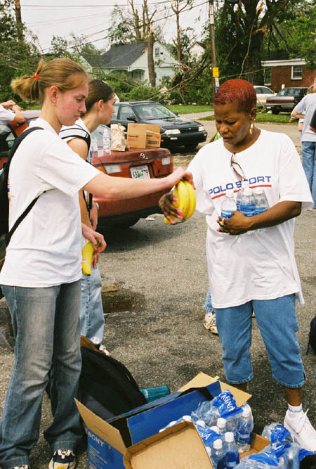 Junior Emily Murbach passes out food and water to tornado victims in downtown Jackson.  Union sent teams out every hour to minister to the victims. - Photo by Justin Veneman