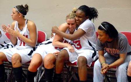 Kayla Hudson and Lavanda Ross share a hug after winning the semifinals of the 2009 NAIA tournament. - Photo by Kristi McMurry Woody