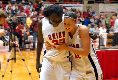 Zeinab Chan and Kaitlin Dudley walk happily off the court after winning the 2009 NAIA championship. - Photo by Kristi McMurry Woody