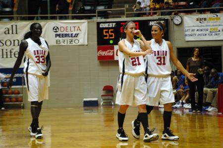 Lindsey Flynn and Merideth Richardson Jacobs share a laugh after the Lady Bulldog's first victory in the NAIA tournament. - Photo by Beth Spain