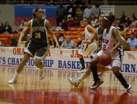 Christina Ray takes the ball down the court in the NAIA tournament game against Point Loma Nazarene. - Photo by Angela Abbamonte
