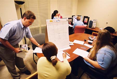 With their power off and a deadline to meet, the <i>Jackson Sun</i> set up camp in the University Relations office to put out their first two issues after the strom. - Photo by Justin Veneman