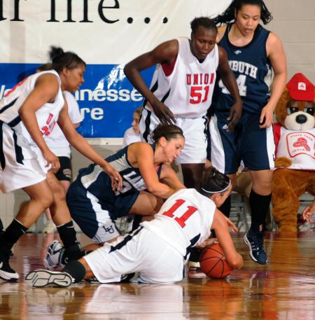 Kaitlin Dudley goes to the floor to fight for the ball during the NAIA national championship game. - Photo by Morris Abernathy