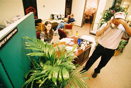 With their power off and a deadline to meet, the <i>Jackson Sun</i> set up camp in the University Relations office to put out their first two issues after the storm. - Photo by Justin Veneman
