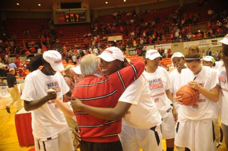 Josephine Owino gets a big hug from Union president, Dr. David S. Dockery. Union claims 2009 NAIA Women's Basketball National Title. - Photo by Morris Abernathy