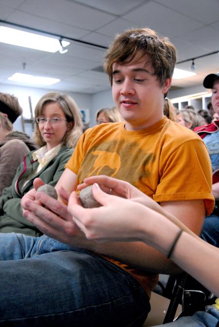 Jonathan Lambach, senior theater/speech major, feels the difference between two clay bodies during the ceramics workshop given by Mark Shapiro. - Photo by Kristi McMurry Woody