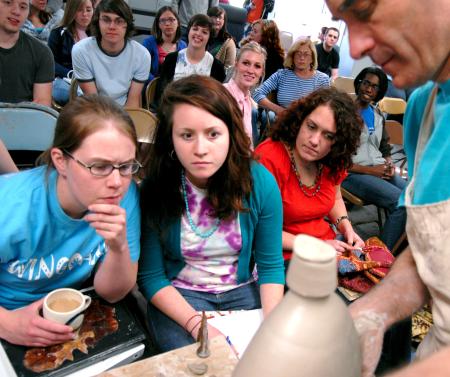 Art students watch closely as Mark Shapiro demonstrates his techniques during a ceramics workshop. - Photo by Kristi McMurry Woody