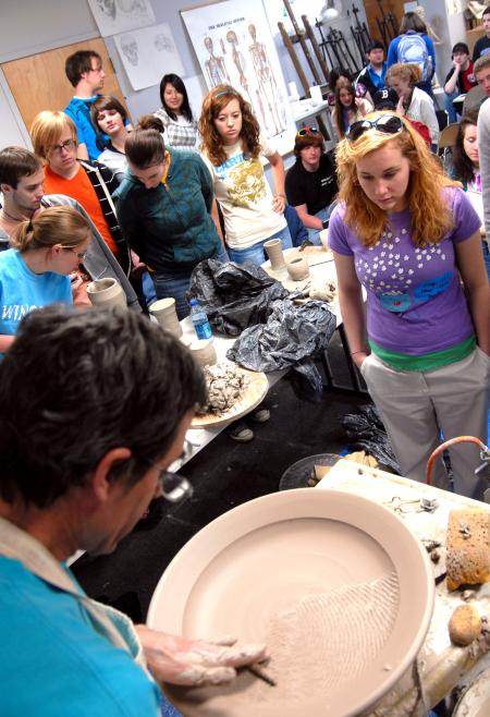 Art students watch closely as Mark Shapiro demonstrates his techniques during a ceramics workshop. - Photo by Kristi McMurry Woody