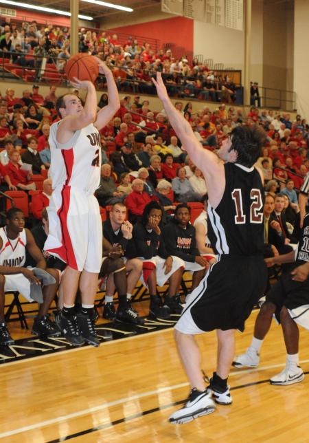 Senior guard Matt Neaville make a three pointer over a Freed-Hardeman (Tenn.) University defender in Union's 105-78 win. - Photo by Morris Abernathy