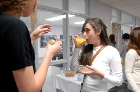 Abby Priddy, junior art major, chats with friends at the annual student art show reception.  - Photo by Kristi McMurry Woody