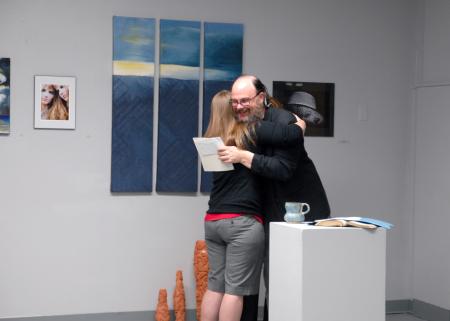 Lee Benson, art department chair, congratulates Paige Ward, junior art major, on her award for the annual student show. Paige won best ceramic piece.  - Photo by Kristi McMurry Woody