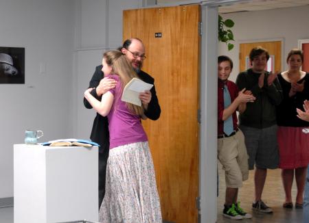 Lee Benson, art department chair, congratulates Kelsey Roberts, junior art major, on her three awards for the annual student show. - Photo by Kristi McMurry Woody