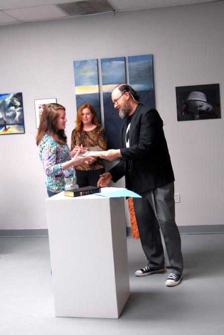 Lee Benson, art department chair, congratulates Kelsey Nagy, sophomore art major, on her scholarship award.  - Photo by Kristi McMurry Woody