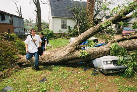 Juniors Jonathan Miller and Melinda Eckley survey the recent damage to homes, vehicles, and land in the downtown Jackson area. - Photo by Justin Veneman