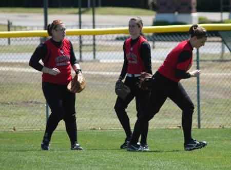 Katie Davis (left), Michelle Albonetti (center), and Kristin Kirk (right) get set to take their defensive positions in the outfield. - Photo by Steven Aldridge