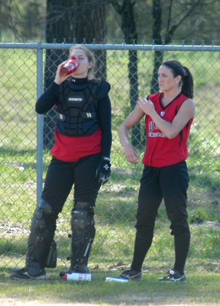 Candice Thompson (left) and Bethany Burnett take a break after throwing in the bullpen. - Photo by Steven Aldridge