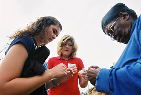 Sophomore Stephanie Ozier and Tara Roggli assist a local tornado victim with medical help. - Photo by Justin Veneman