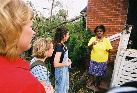 While performing a needs assessment in the community, Union students stop to listen to a tornado victim's story. - Photo by Justin Veneman