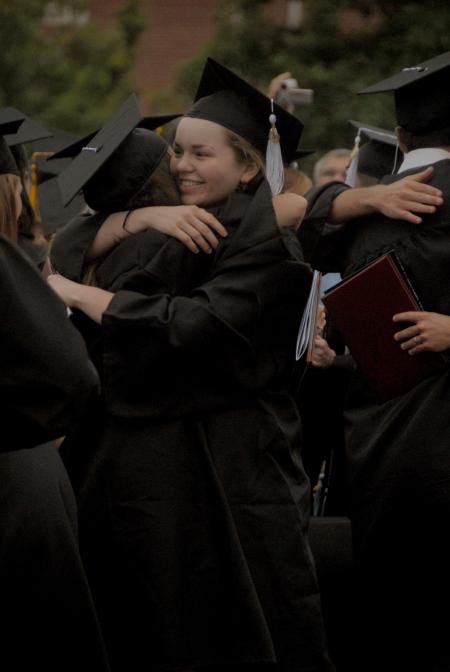 Tiffany Fredericks, French graduate, hugs a friend at the conclusion of the spring commencement service. - Photo by Angela Abbamonte
