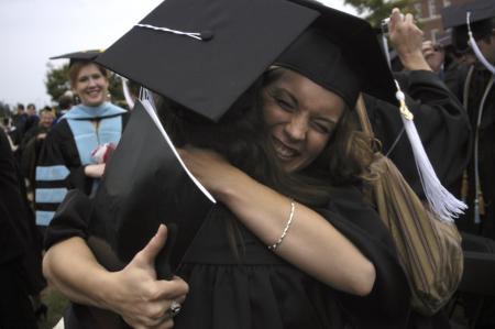 Heather Childers hugs Ashley Deihm after the spring graduation ceremony. - Photo by Sarah Palmer Goff