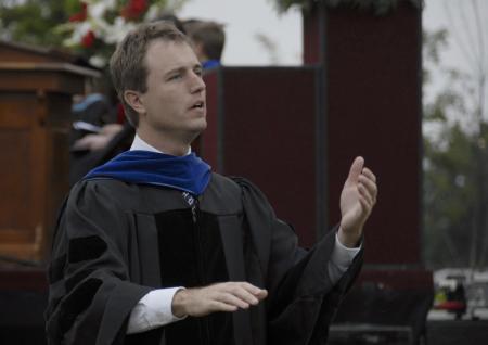 Chair of the department of music, Chris Mathews, conducts the Union University Singers in the anthem, <em>All That Hath Life and Breath Praise Ye the Lord!</em> during spring graduation. - Photo by Jim Veneman