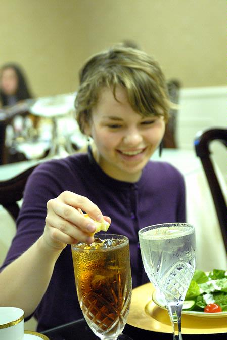 Tiffany Fredericks, senior marketing major, squeezes lemon into her tea at the 2009 Etiquette Luncheon.This annual event, hosted by First Lady Lanese Dockery and Sherry Tignor, teaches students proper interview etiquette. - Photo by Kristi McMurry Woody