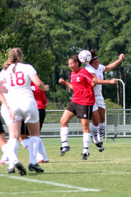 Bridget Roney, sophomore athletic training major, goes up for a header against her Christian Brothers opponent. - Photo by Kristi McMurry Woody