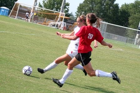 Evie Felts, freshman, prepares to pass the ball to keep it away from her Christian Brothers opponent. - Photo by Kristi McMurry Woody