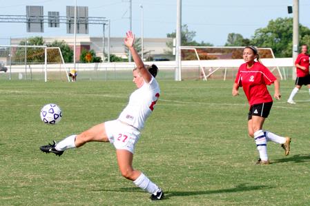 Katelin Dirksen, senior business administration major, stretches out to stop the ball. - Photo by Kristi McMurry Woody