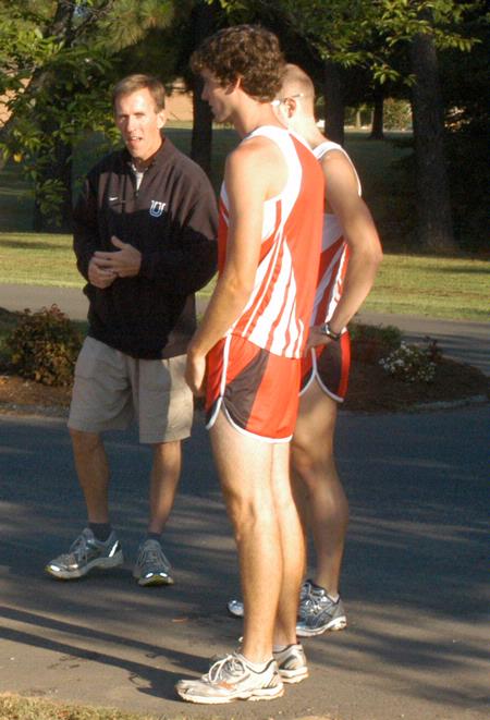 Cross country head coach Gary Johnson talking with his runners prior to practice. - Photo by Steven Aldridge